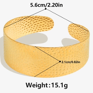 Detail of 18k gold plated stainless steel cuff bracelet with handcrafted hammered texture