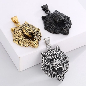 Detailed view of three wolf head pendants in gold, black and silver stainless steel