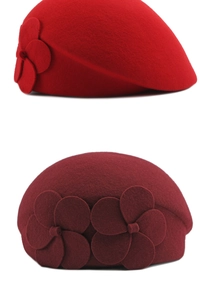 Detail of wool beret showing red and wine red colors with 3D floral accents