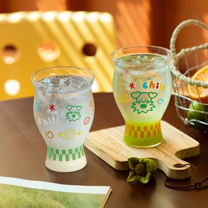 Borosilicate glass coffee cups with cartoon patterns and colored grid bases in sunlight
