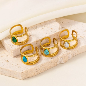 Detailed macro view of four adjustable gold-plated steel rings with inlaid stones
