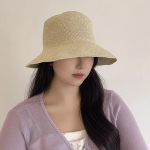 Handcrafted crochet straw sun hat for women featuring a minimalist beige woven design