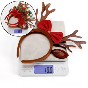 Brown reindeer antler headband with red bow and HO HO HO text, 3-piece set weight display