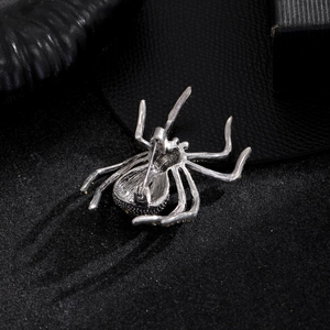 Silver spider brooch showing back pin structure and secure rotating clasp detail