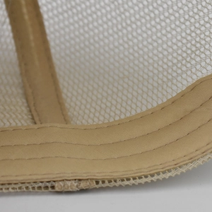 Macro detail of khaki ponytail baseball cap showing breathable mesh and durable stitching