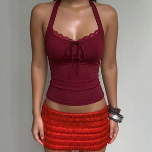 Detail of burgundy lace halter top with open back and red tassel mini skirt set