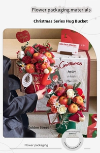 Close-up of festive Christmas flower bucket with gold accents and holiday ornaments