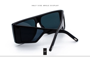 Detailed 180 degree side view of oversized black square sunglasses with silver hinges