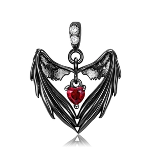 Detail of angel wing pendant with red heart stone and crystal inlay on a polished finish