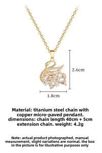 Detail view of gold swan pendant with micro-pave zircons and titanium steel chain