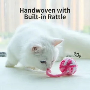 Hand-woven pink and white yarn cat toy ball with built-in bell for indoor cats