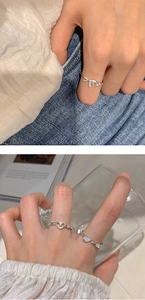 Detail of silver bow and hollow heart rings with sparkling cubic zirconia stones