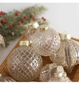 Detailed view of clear Christmas ornaments with glitter diamond patterns and gold caps