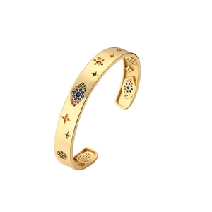 Gold open bangle featuring evil eye and star charms with colorful zircon stones