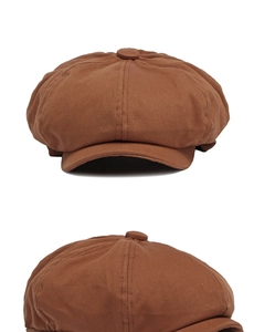 Detailed view of brown cotton twill newsboy cap showing top button and 8-panel stitching