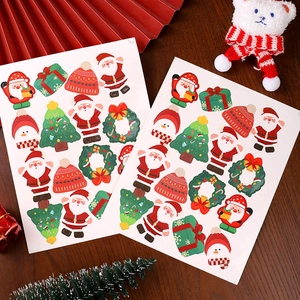 Cartoon Christmas stickers set featuring Santa, snowmen and trees on a warm wooden desk
