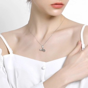 Silver microphone pendant necklace worn by a model for music lovers and jewelry gifts