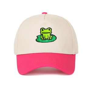 Close-up of a green frog on lily pad embroidery on a beige and pink trucker hat