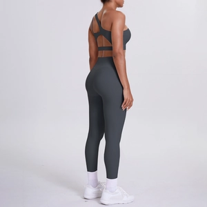 Deep grey yoga set featuring cross-back sports bra and high-waisted leggings