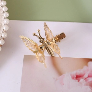 Exquisite golden metal butterfly hair clip with fine details and a vintage style finish