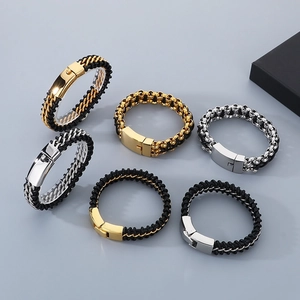 Detailed shot of braided leather bracelets with titanium steel chains in gold and silver