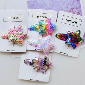 Close-up of 5-piece glitter hair clip set featuring stars and teardrops on a princess card