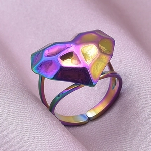 Macro shot of iridescent heart ring with geometric cut and adjustable double band