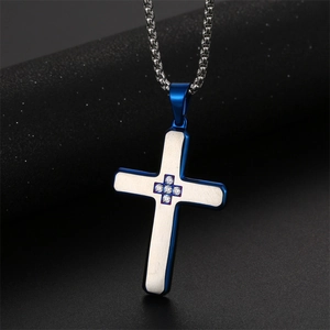 Silver and blue cross pendant necklace with small diamonds on dark background