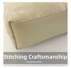 Detailed macro view of the seamless stitching and marble-textured leather on the bag corner