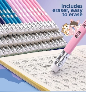 Close-up of HB pencils with ergonomic grip and eraser tips on a grid practice notebook
