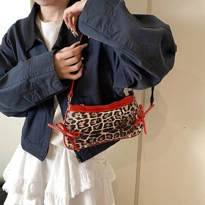 Retro leopard print shoulder bag with red patent leather trim and bow details
