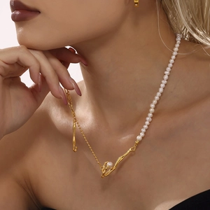 Modern baroque pearl necklace with gold liquid metal chain worn on model's neck