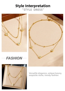Detail of double-layer gold necklace with Roman numeral pendants and crystal inlays