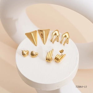 Set of four gold-plated titanium steel earrings in geometric and heart shapes on display