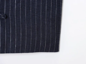 Macro view of navy blue striped linen-blend fabric with detailed button loop stitching
