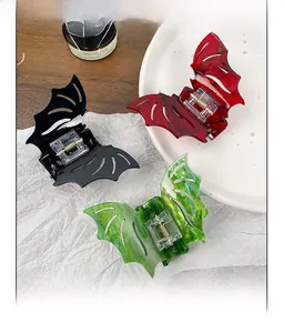 Detailed view of gothic bat hair claws in black, red, and green marble textures