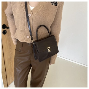 Vintage dark brown leather handbag with gold metal clasp and top handle for women
