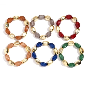 Bohemian acrylic beaded bracelets set with irregular oval beads and gold glitter texture