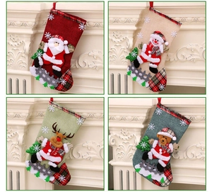 Detailed view of four linen Christmas stockings with 3D Santa, Snowman, Reindeer, and Bear