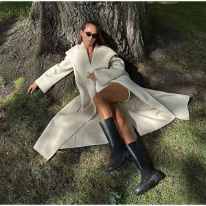Elegant long beige wool coat with oversized lapel and belted waist for women in autumn