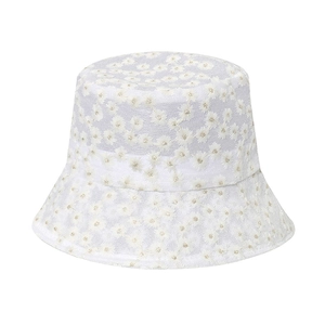 Close-up of delicate white lace mesh fisherman hat with intricate daisy flower embroidery