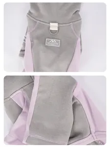 Close-up of dog hoodie with gray knit fabric, pink trim, integrated D-ring and logo patch