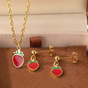 Detail of strawberry necklace and earrings set in a velvet gift box with gold finish