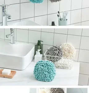 Close-up of soft chenille hand towels in cyan, grey and beige with hanging loops