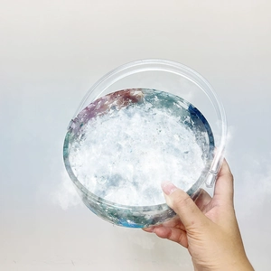 Handcrafted round resin tote bag mold with dreamy feathers and colorful dried flowers