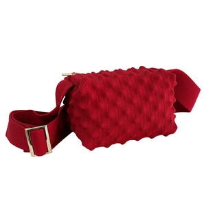 Red candy-colored knit crossbody bag with trendy bubble texture and wide shoulder strap