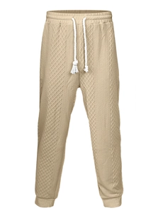 Detail of light khaki jacquard jogger pants featuring drawstring waist and diamond texture