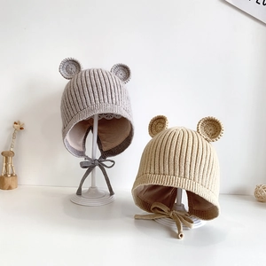 Detail von Baby-Strickmützen mit Bärenohren in Grau und Beige mit verstellbaren Bändern