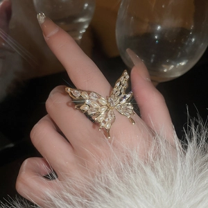 Close-up of gold plated butterfly ring featuring white pearls and shimmering zircon stones