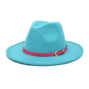 Detail of teal wool fedora hat featuring a contrasting pink leather belt and gold buckle